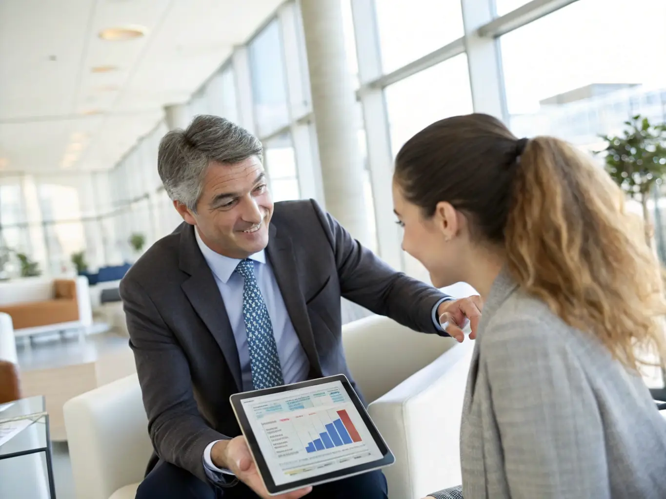An image of a financial advisor presenting a financial plan to a client, with charts and graphs displayed, in a comfortable and professional setting, representing financial planning services.
